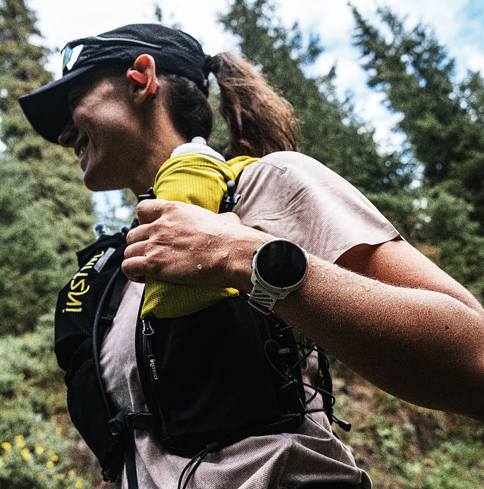 Trail runner wearing Suunto Race 3S on a mountain path