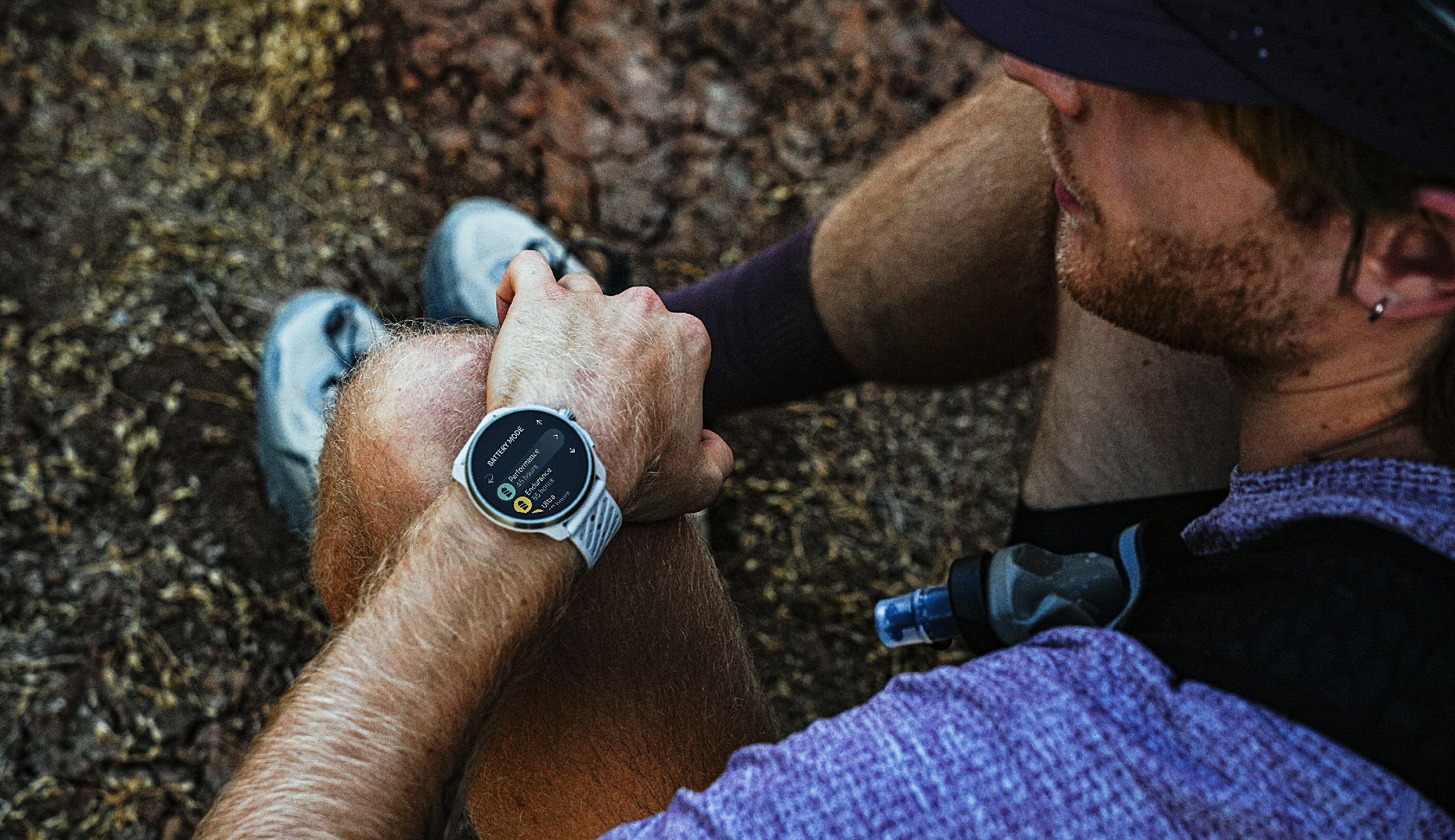 Trail runner checking the battery mode on Suunto Race 3S
