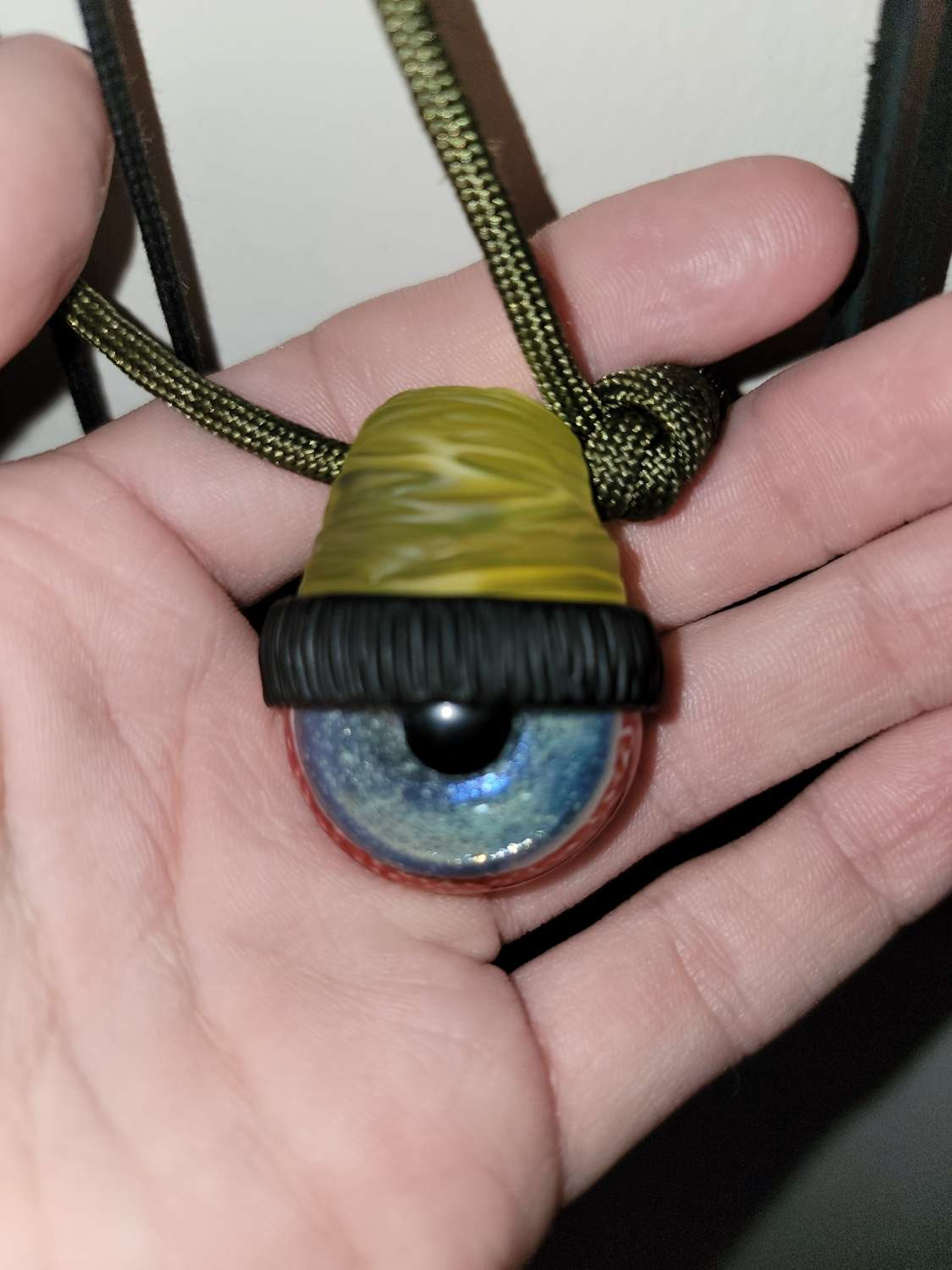 Junkie Glass:
•Beanie Eye Pendant ($100) image 0
