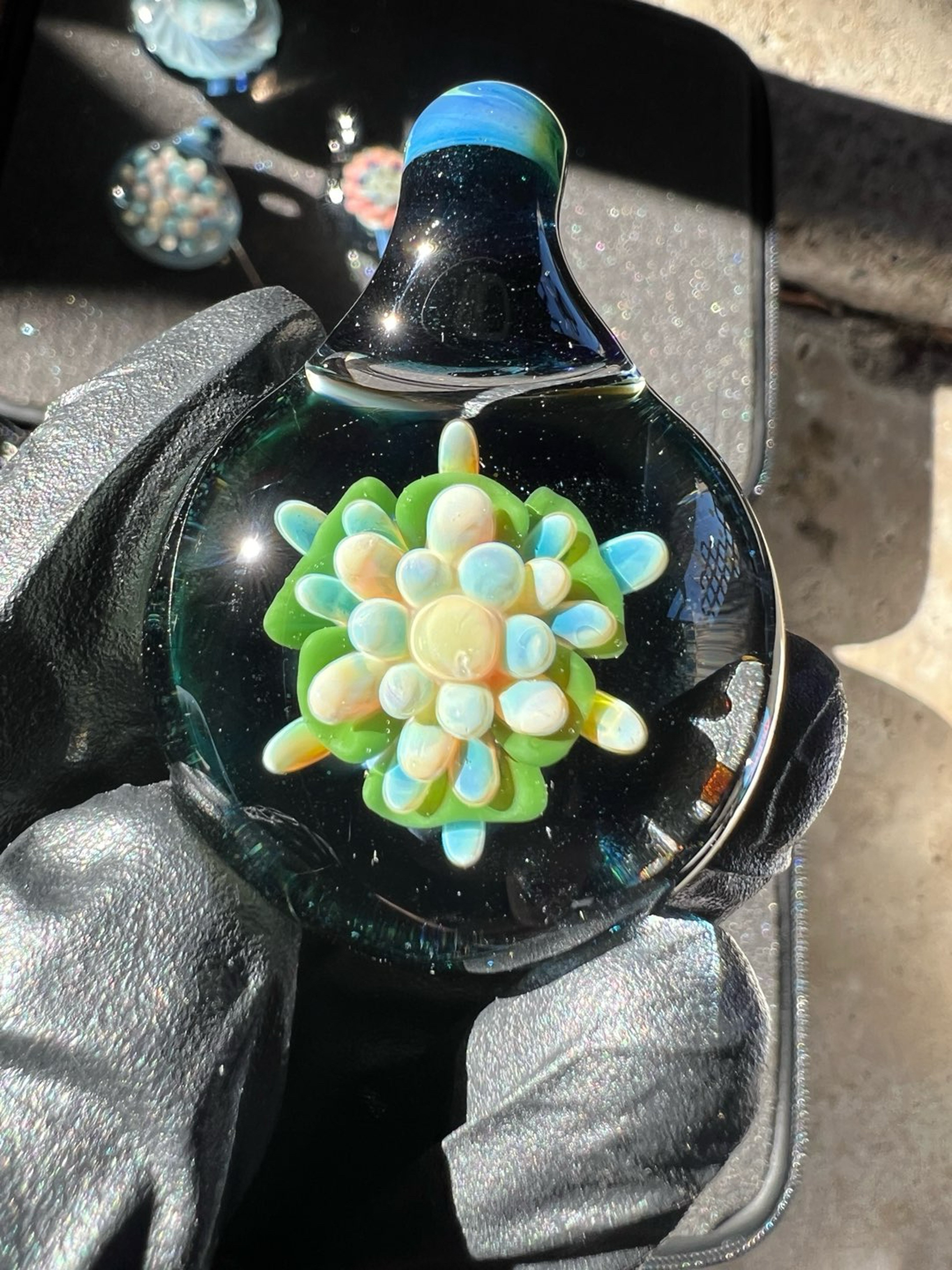 Preview pic of Flower implosion pendant, with a heavy blue stardust backing.