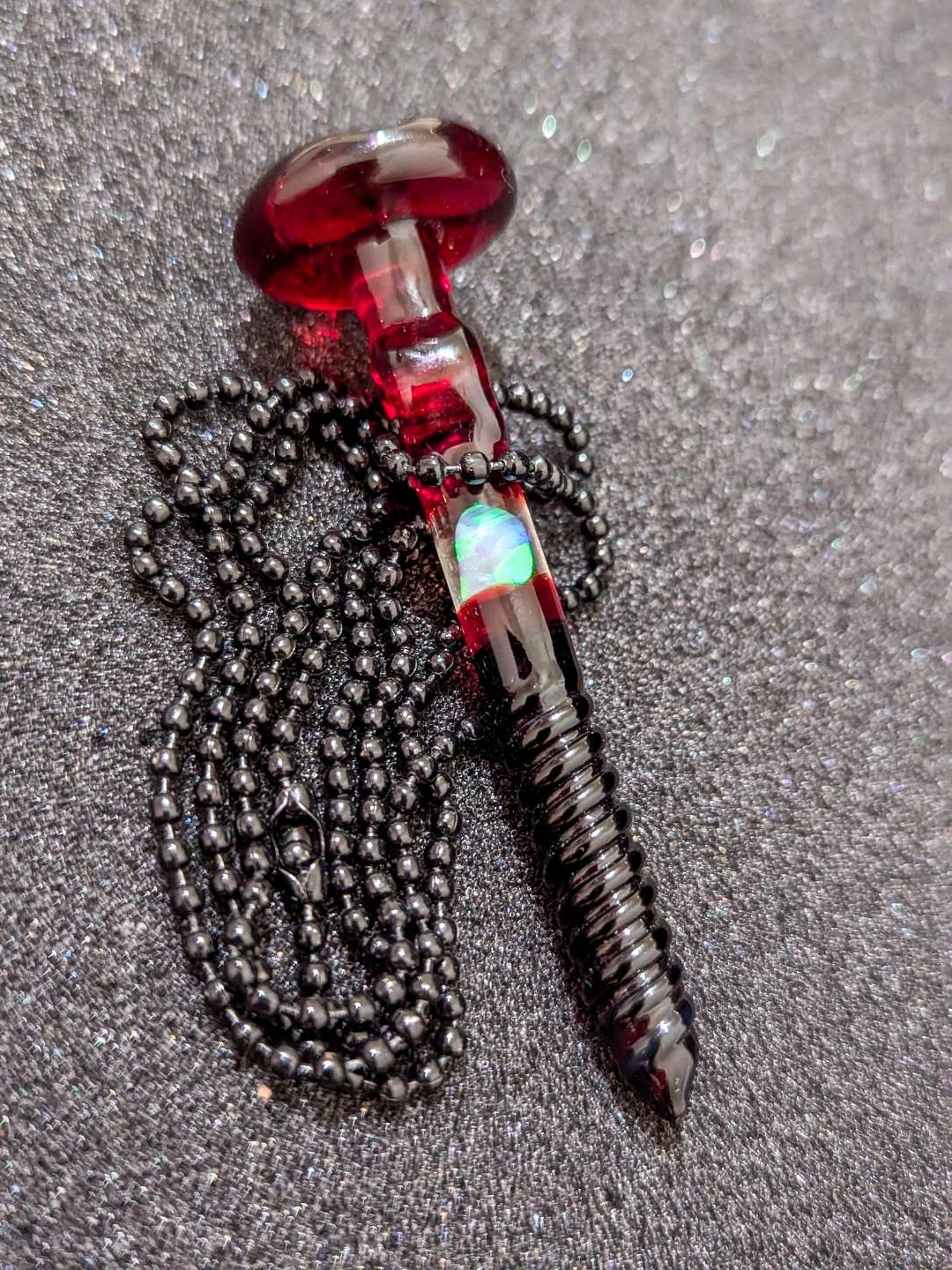 Preview pic of Takoda Madrona’s deep red and black screw pendant with a stunning opal centerpiece—pure artistry, no reserve! Don’t miss out! 🚨🔥