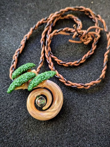 Preview pic of 🌿 Bonsai Flex, Butcher Style 🌿
Original 1 of 1 full-size spiral bonsai pendant by Bubbles the Butcher, featuring a glowing opal core and hand-braided triple leather cord. Collector heat. 💎