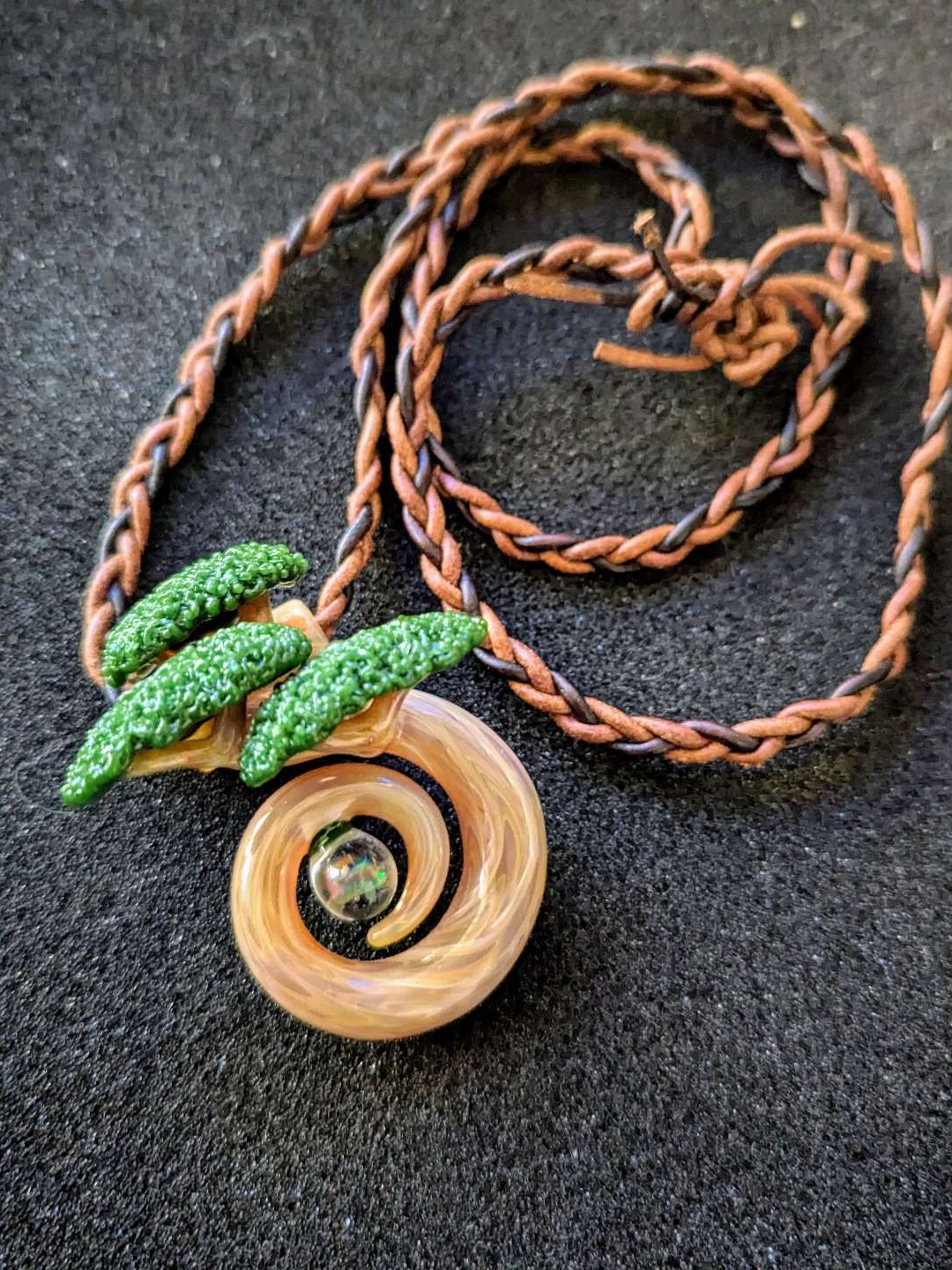 Preview pic of 🌿 Bonsai Flex, Butcher Style 🌿
Original 1 of 1 full-size spiral bonsai pendant by Bubbles the Butcher, featuring a glowing opal core and hand-braided triple leather cord. Collector heat. 💎