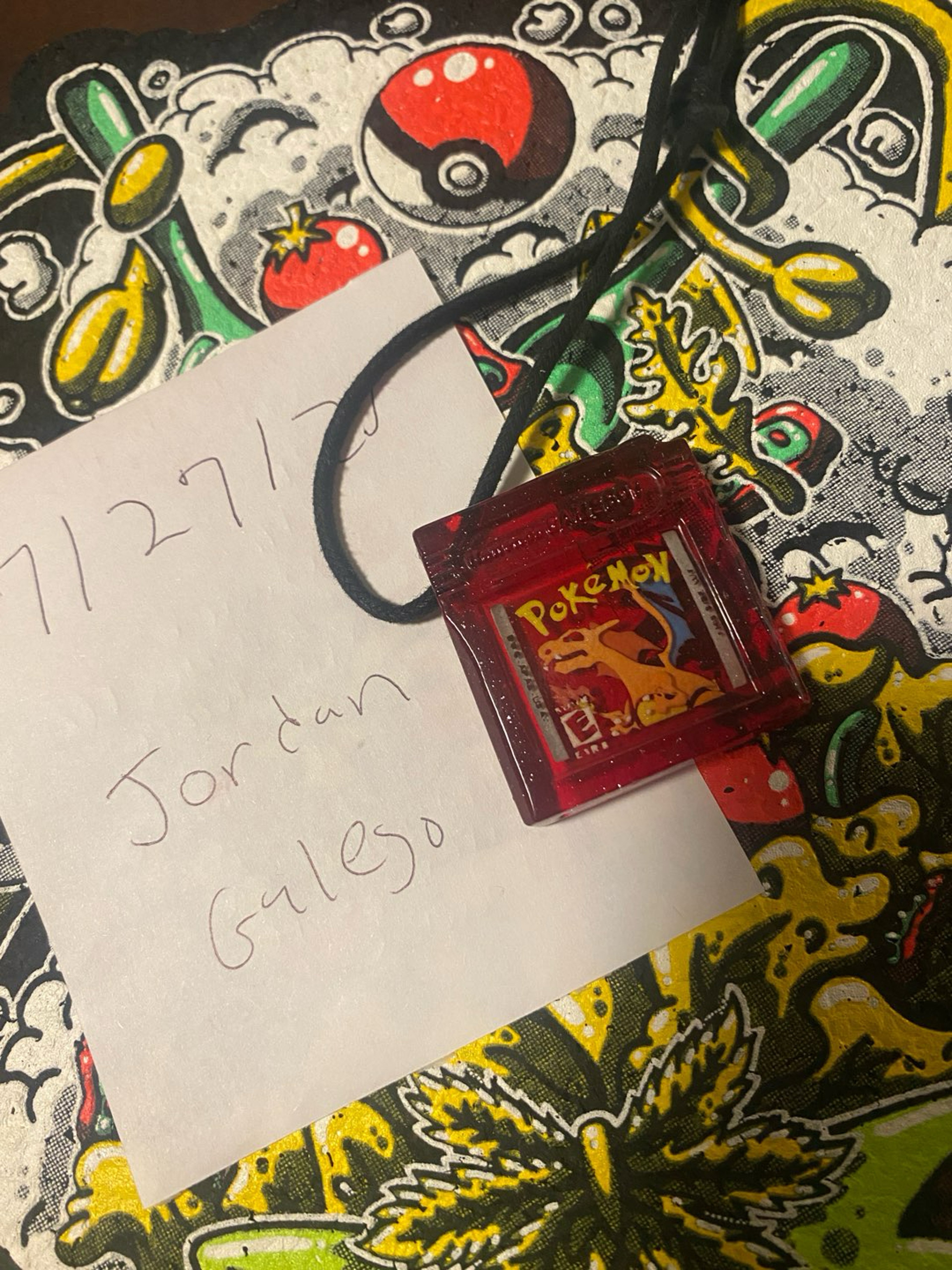 Preview pic of Glass game boy charizard  necklace UV glow