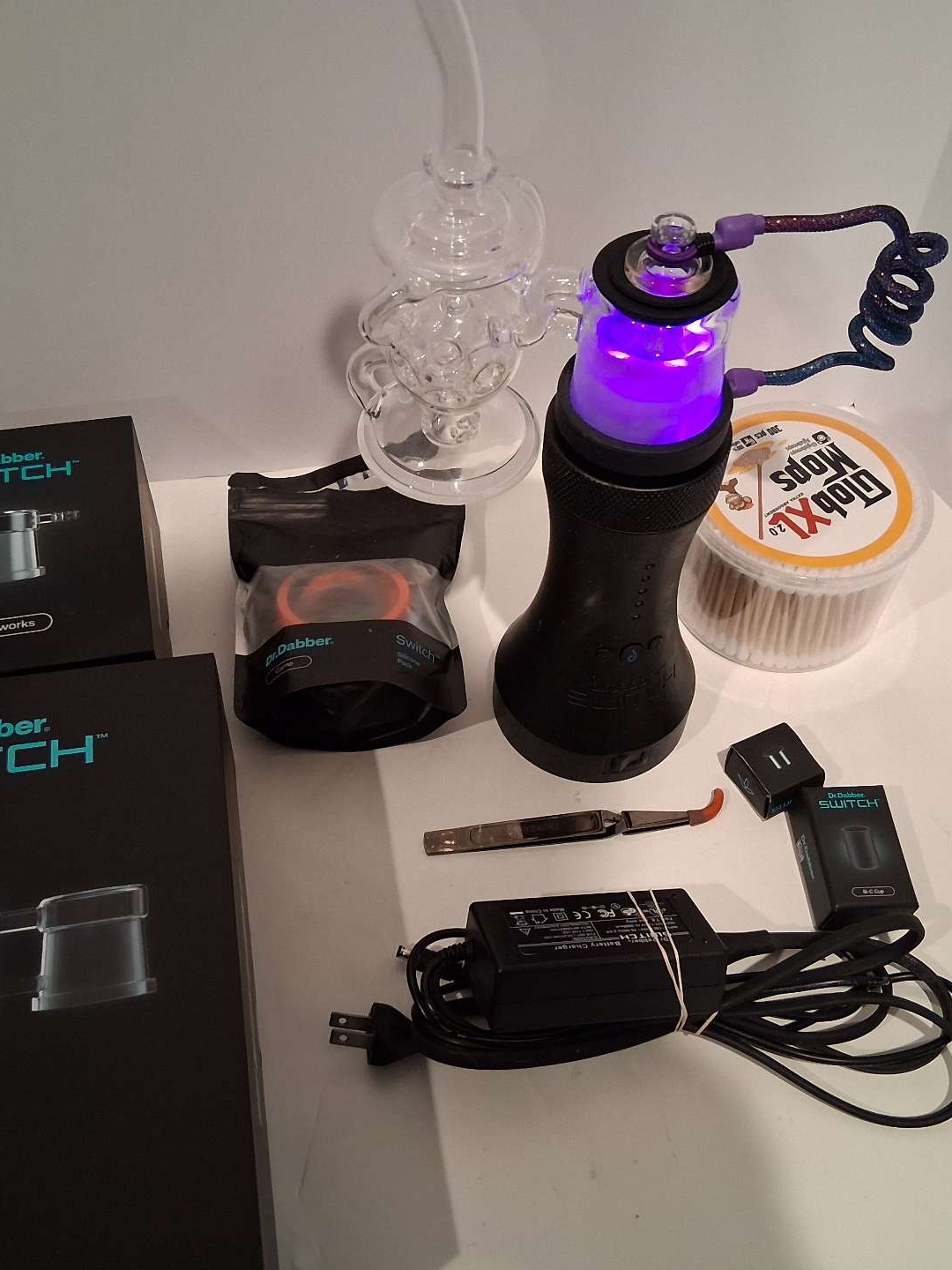 Preview pic of Dr Dabber Switch w/ SiC, Leaf, Tweezers, Power Cable, Silicone Pack, Sidecar Perc, Switch Whip Attachment, and the Sidewinder (mounted on now)