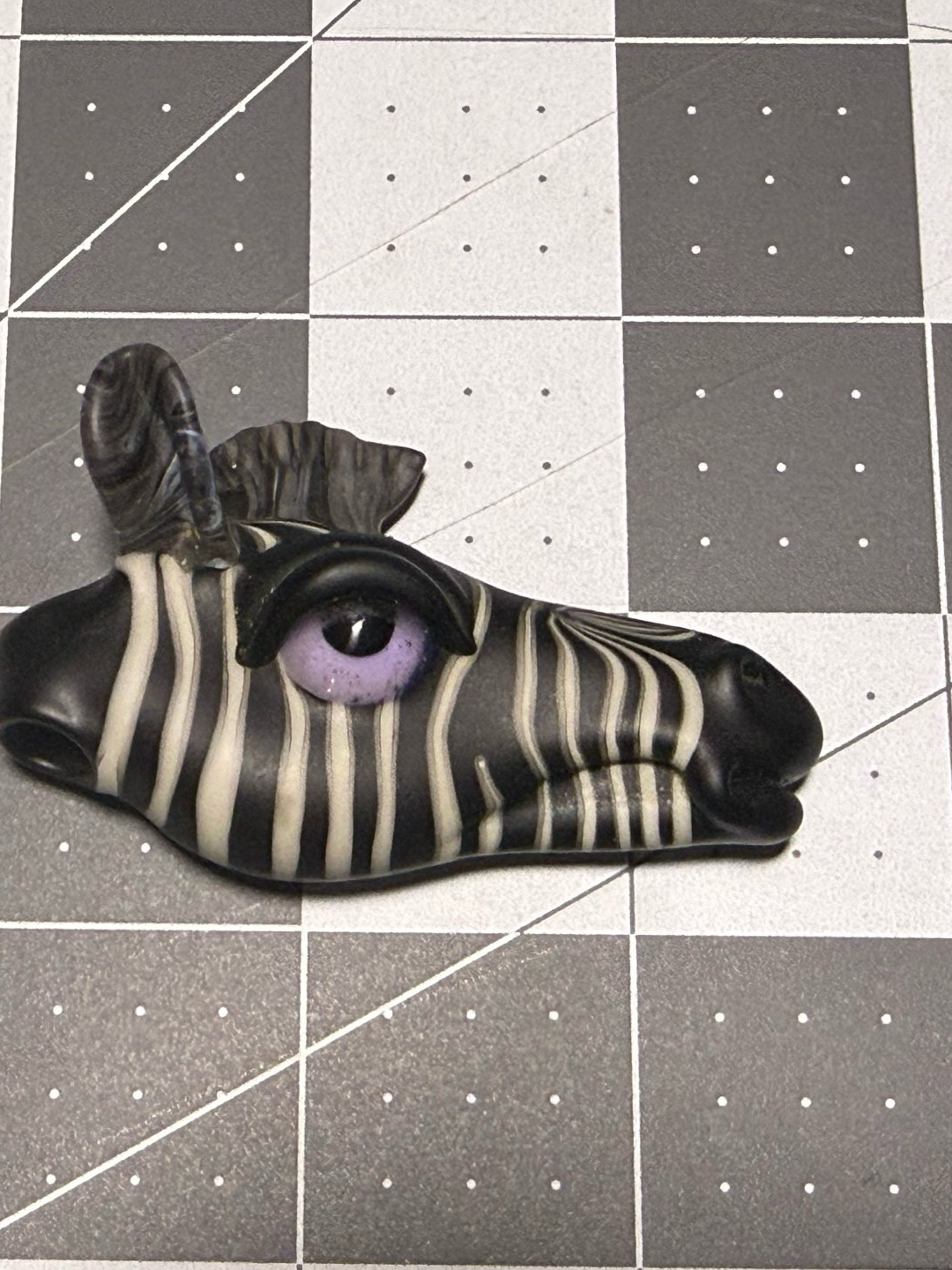 Preview pic of Robertson Zebra head pendant with purple eye