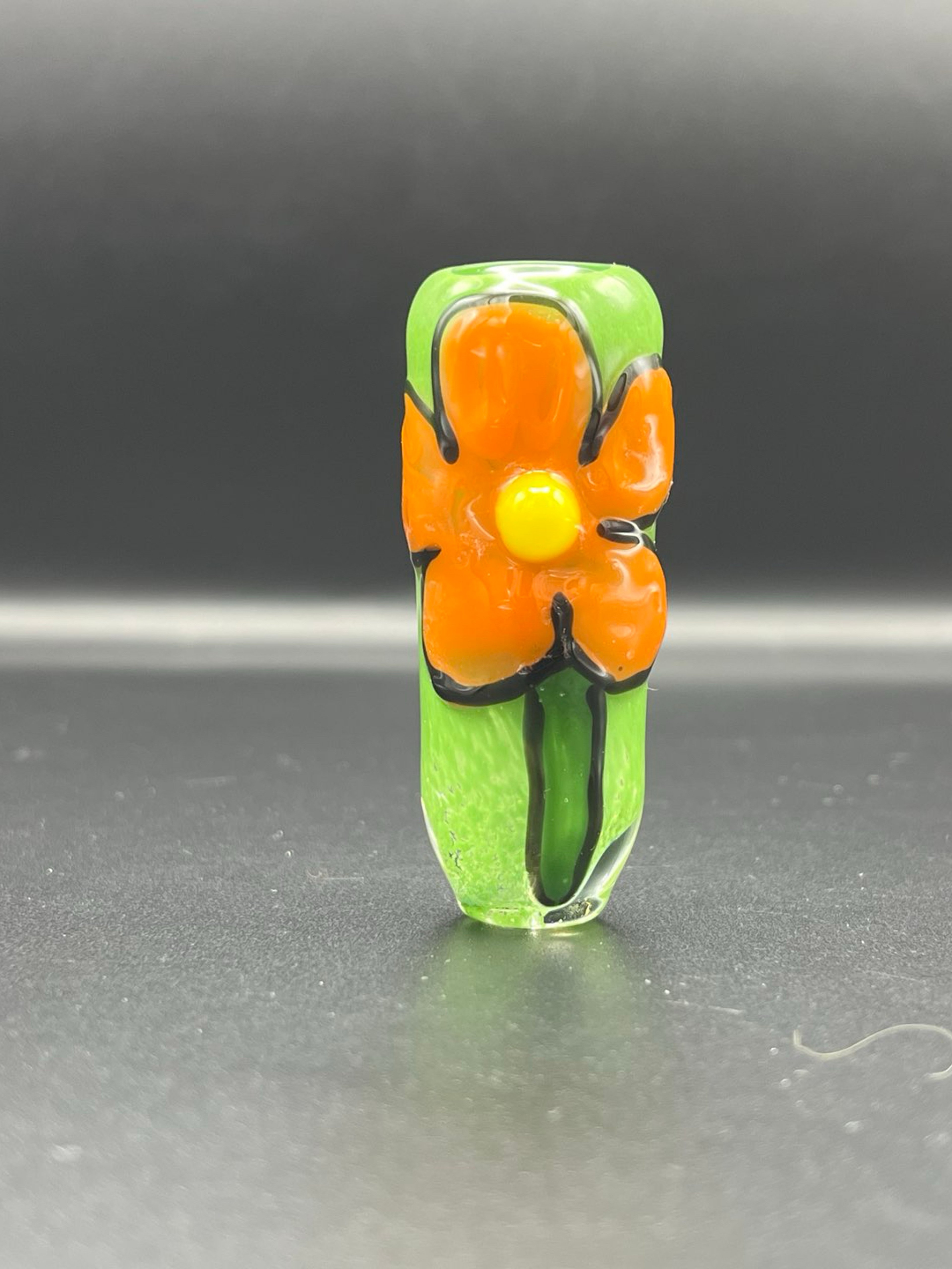Drawn orange flower over jade chillum. image 0
