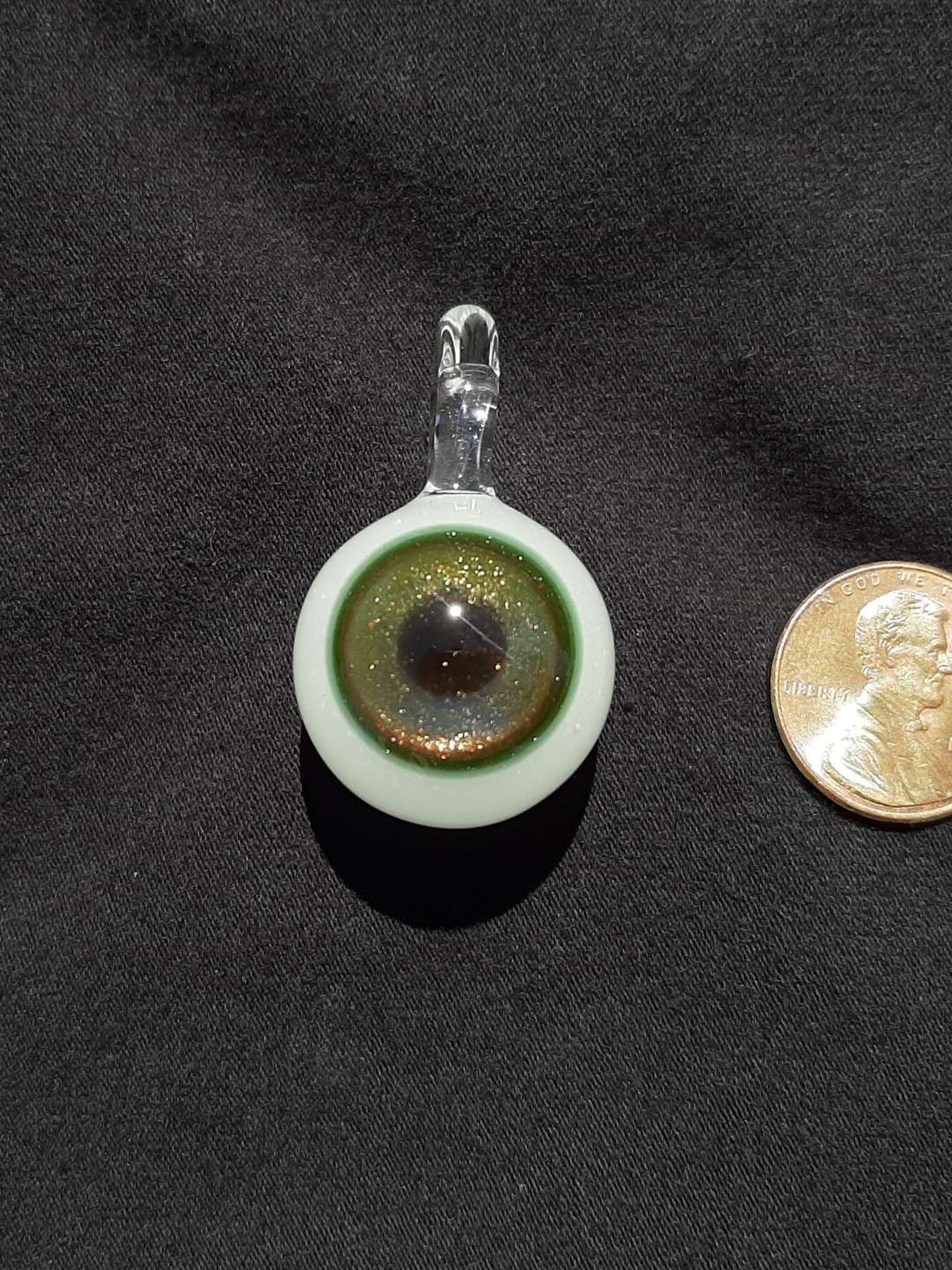 Preview pic of Glow in the dark, sparkly, borosilicate glass eyeball pendant
