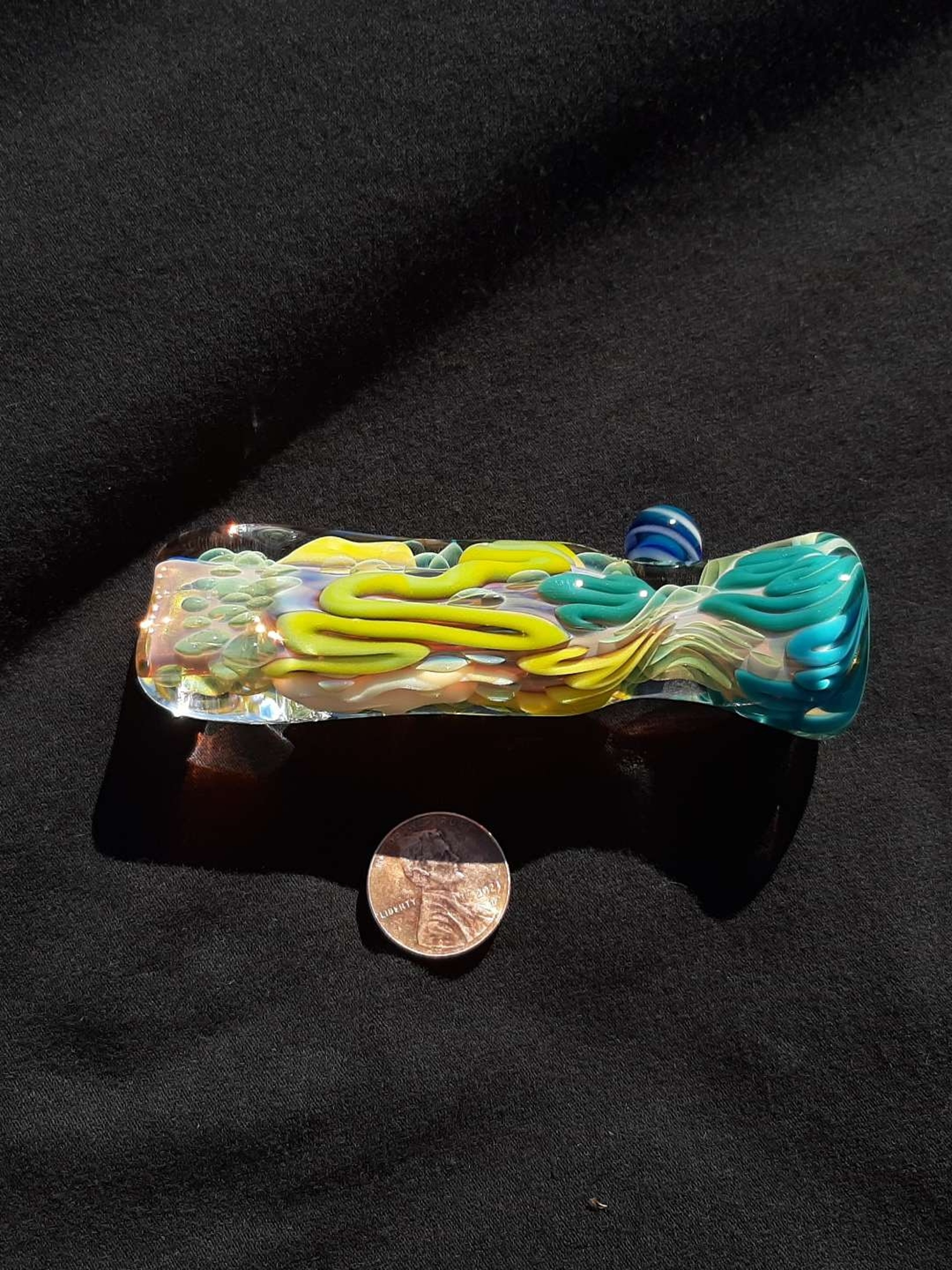 Preview pic of Inside out, color changing, borosilicate glass chillum with a flattened mouth