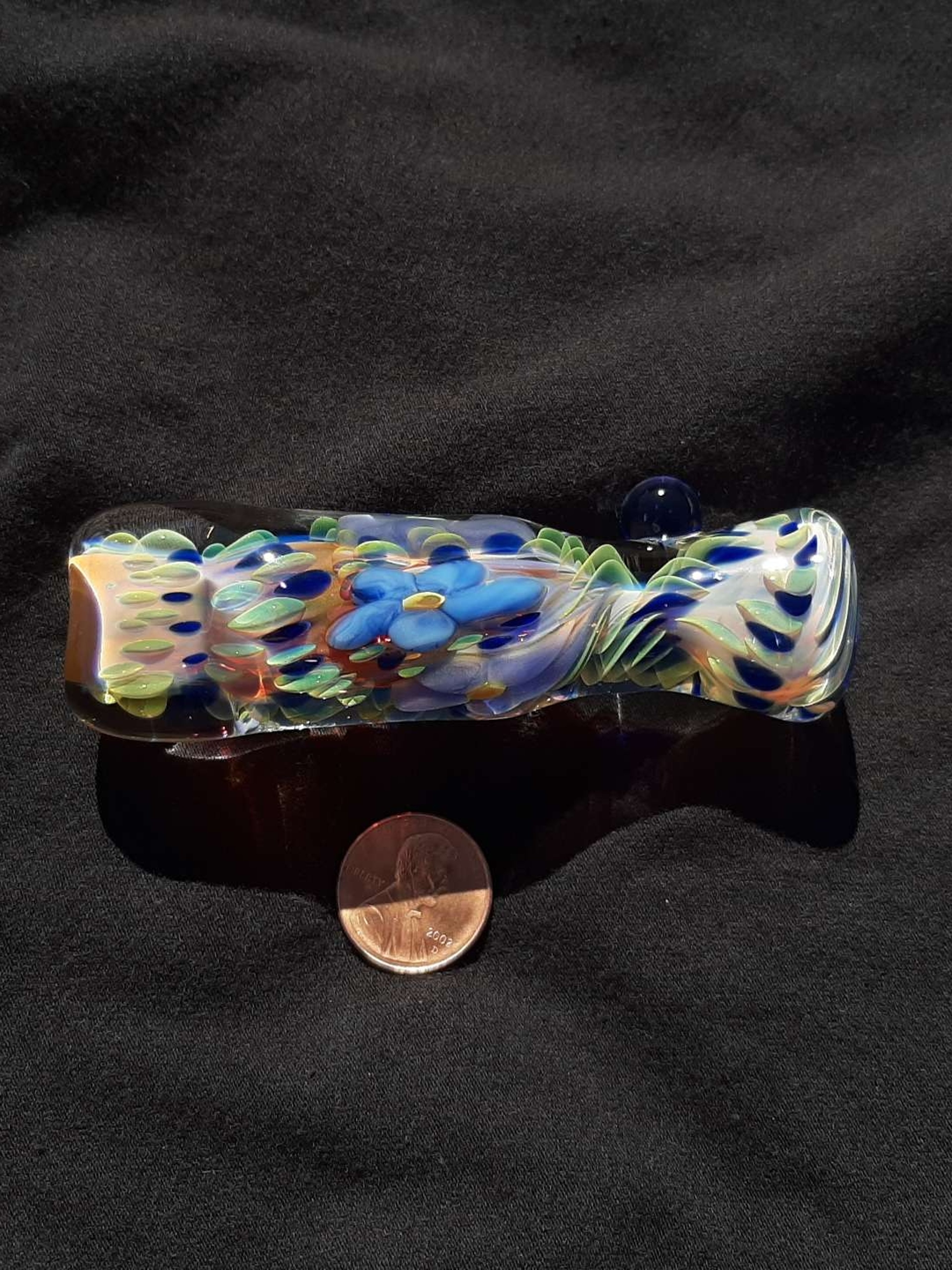 Preview pic of Inside out, color changing, borosilicate glass flower chillum with a flattened mouth