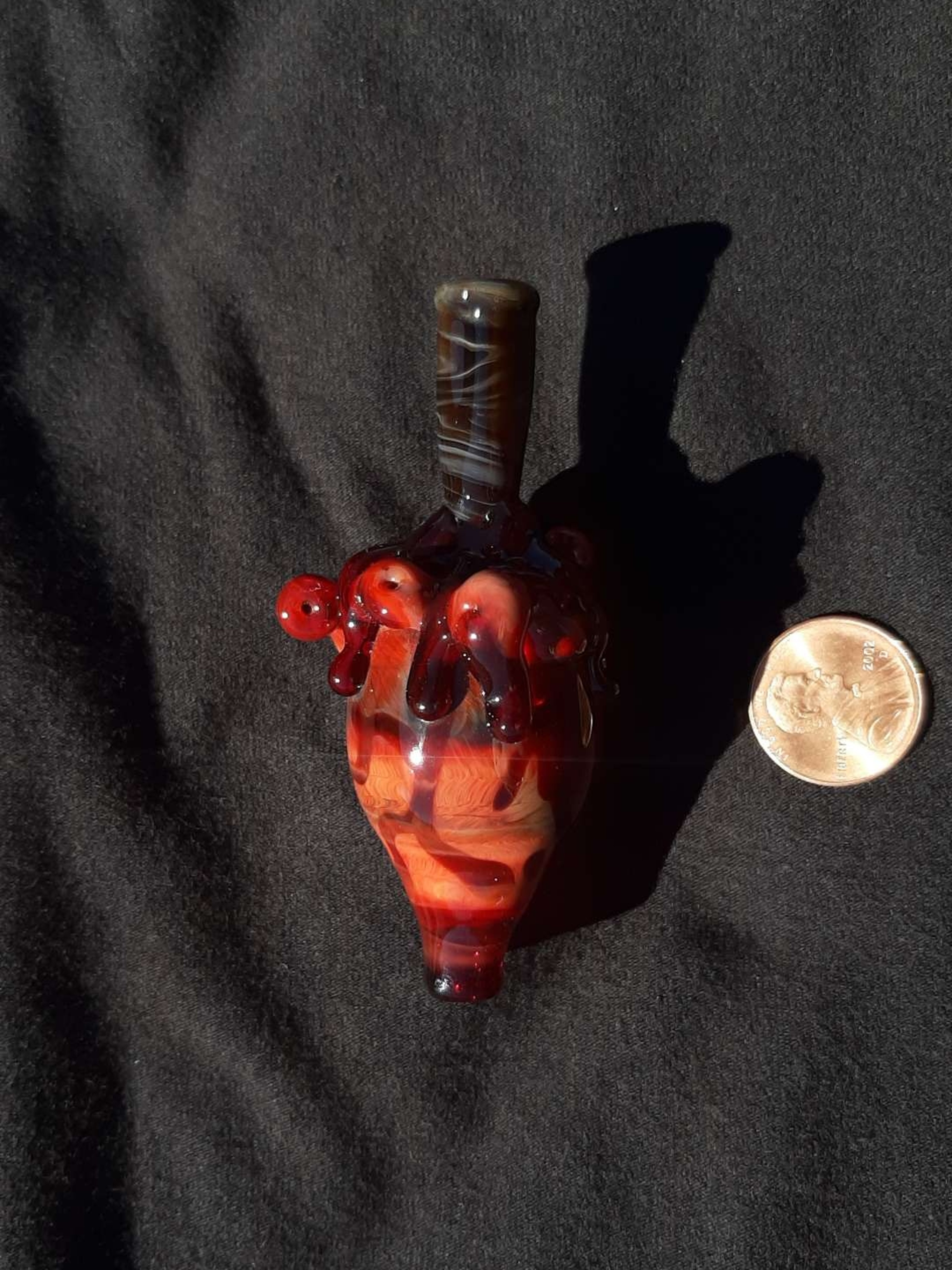 Preview pic of Coiled, bloody heart, borosilicate carb cap with a wood grain stake for a handle