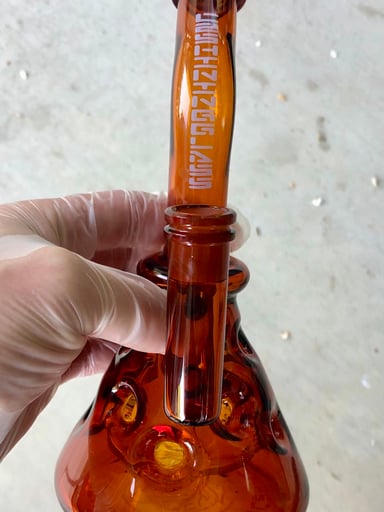 Preview pic of Shining Glass 10" Amber Swiss-Body Rig | 14mm Showerhead | UV-Reactive Logo