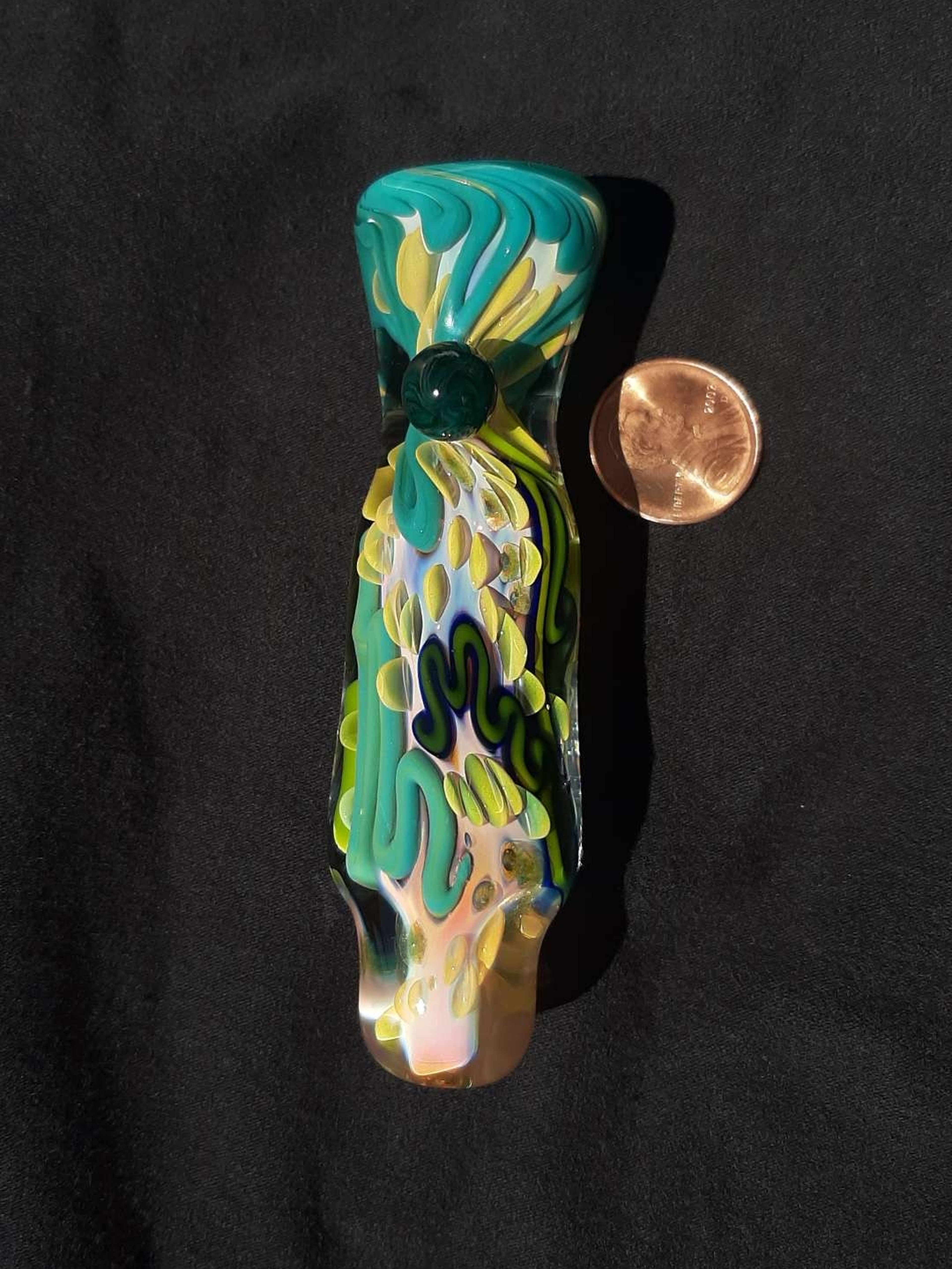 Preview pic of Inside out, color changing, borosilicate glass chillum with a flattened mouth