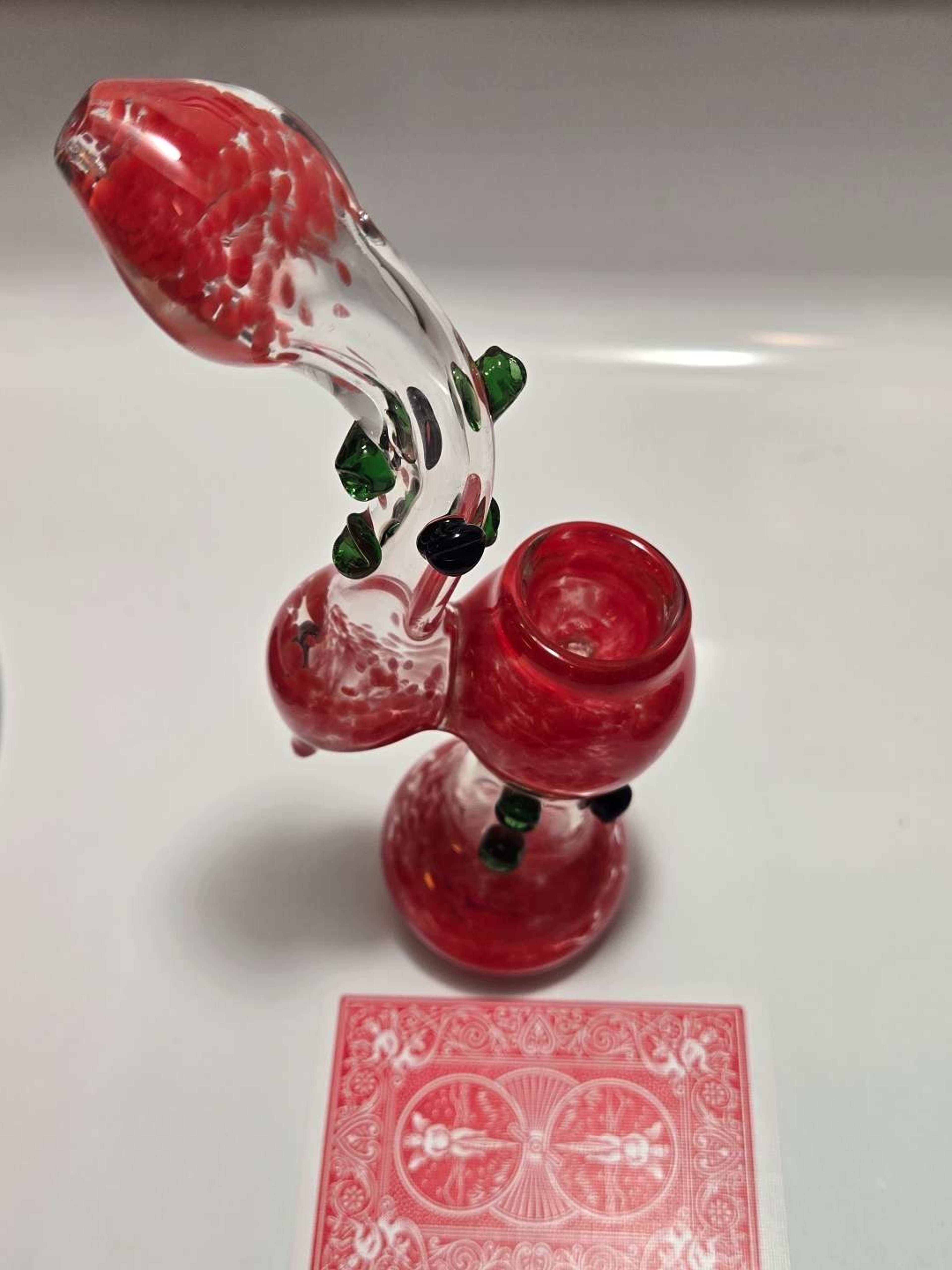 Standing red frit bubbler with green/black marbles. image 0