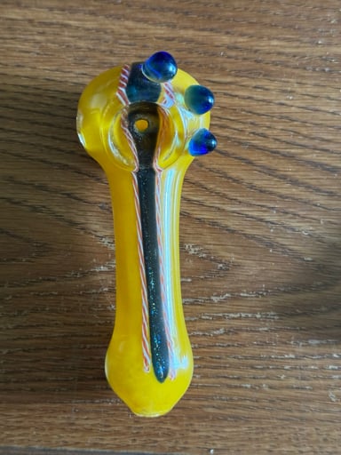 Preview pic of Bright yellow spoon with blue marble accents + black/orange cane work