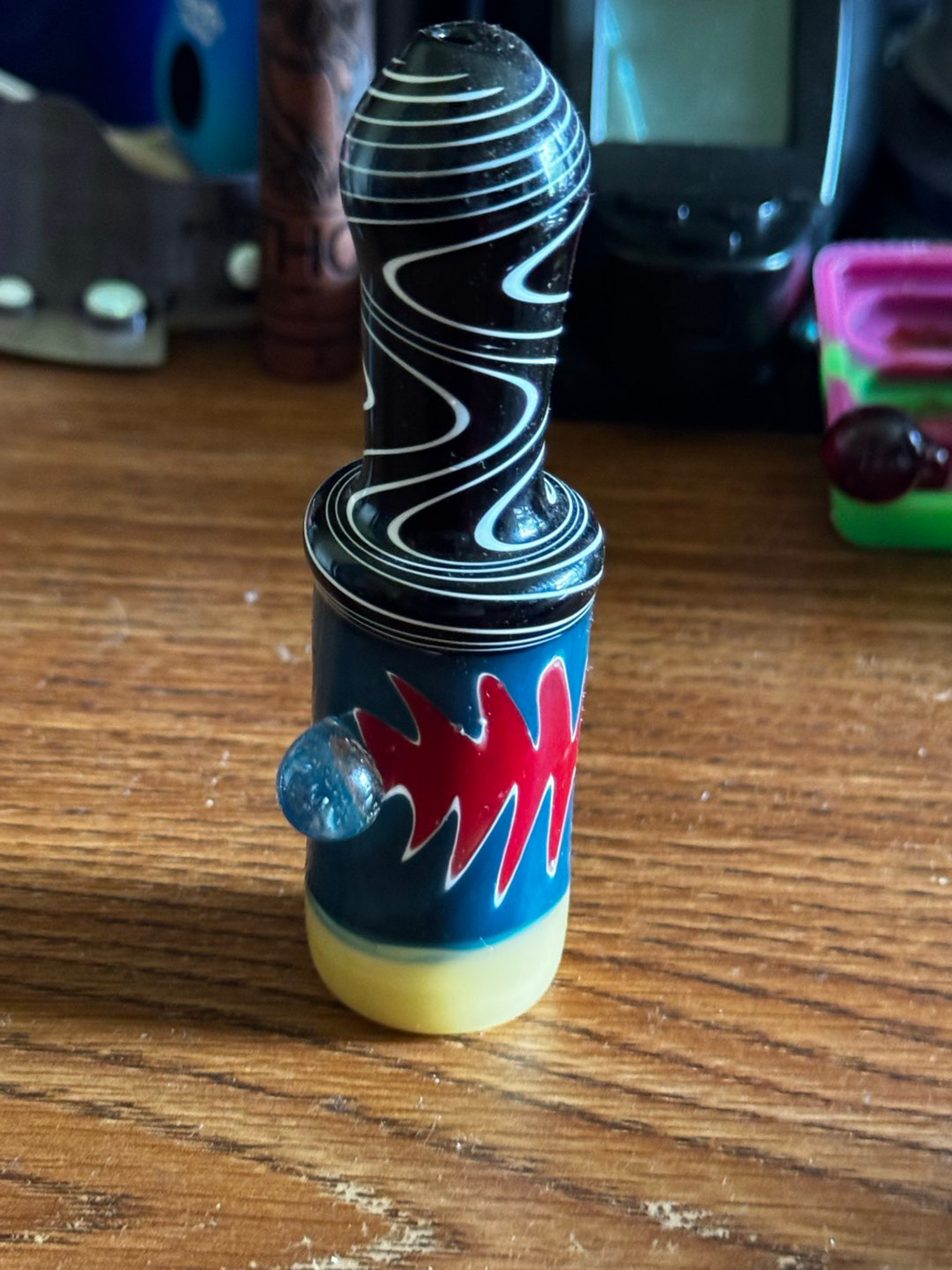Preview pic of Black + white swirl top chillum with blue body + red flame work and yellow base