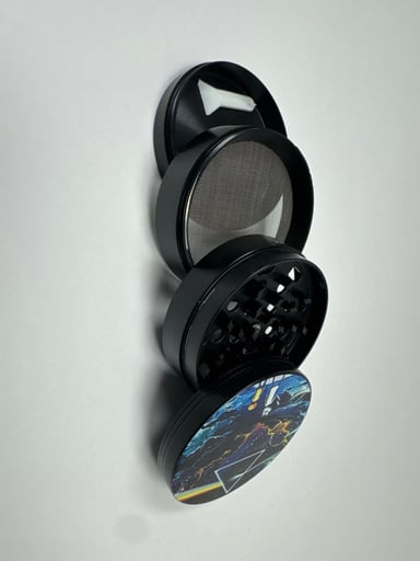 Preview pic of Rick and Morty four piece grinder black  with kief catcher and kief scraper spoon