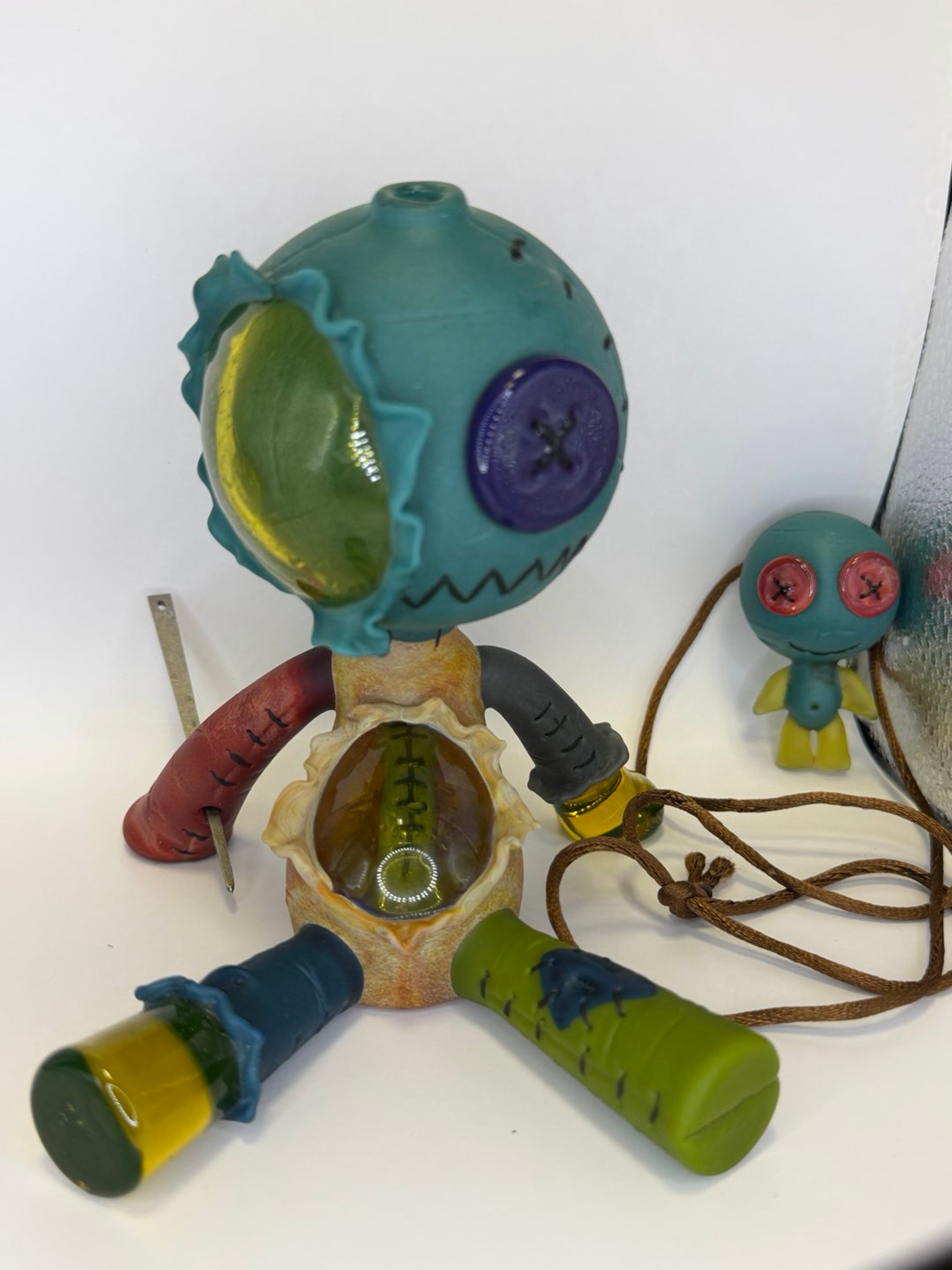 Preview pic of Multi Colored Patch Work & UV Reactive Torn Sitting Muller Doll & Pendant