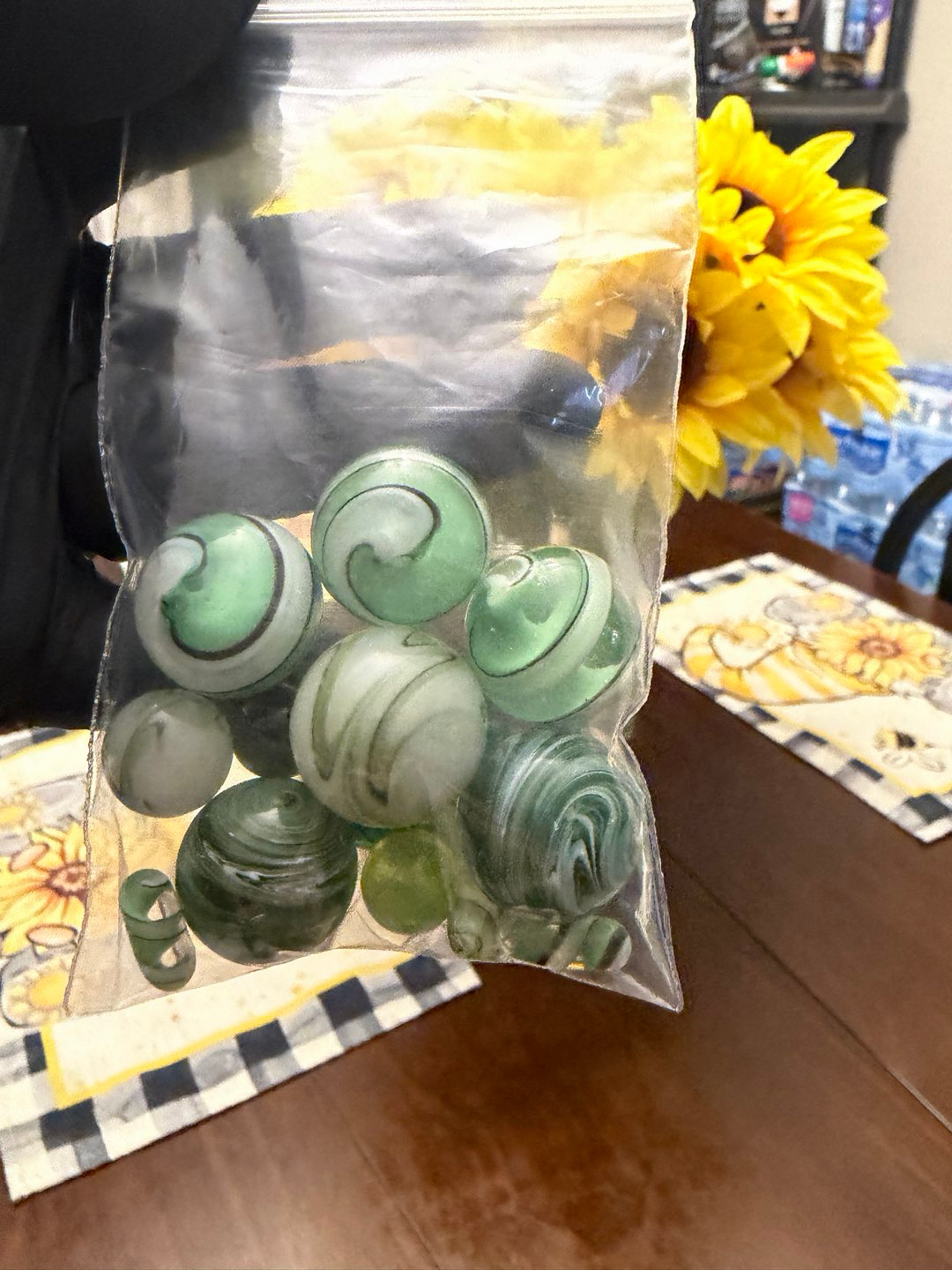 Miscellaneous green marbles and pills image 0