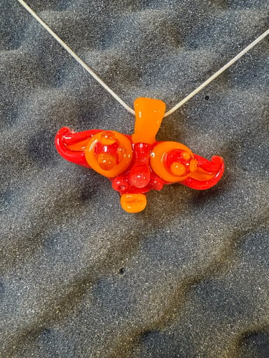 Preview pic of Orange and red Sunya glass trip sitter