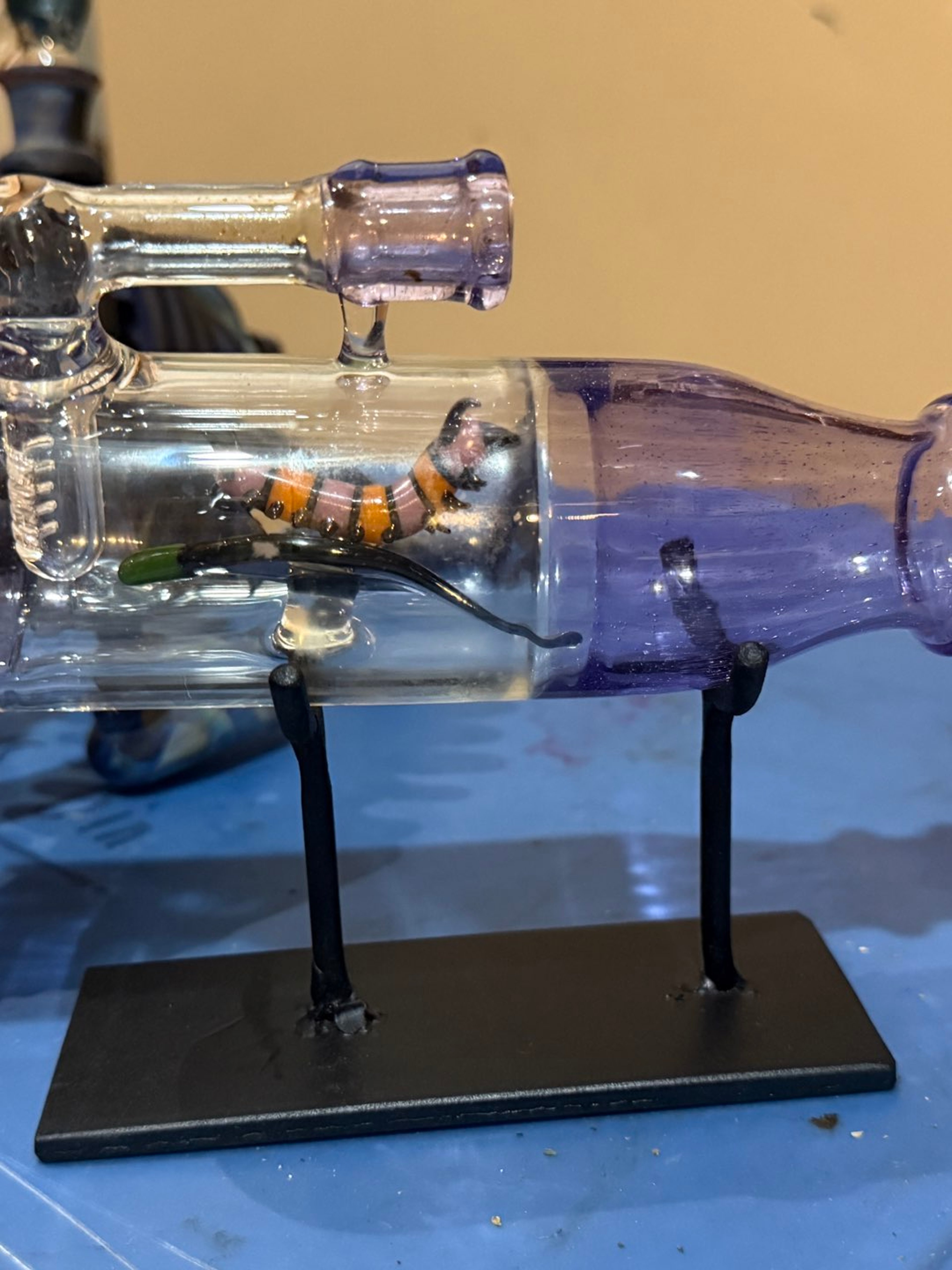 Caterpillar in a bottle | Shop Robert Mickelsen on GlassPass