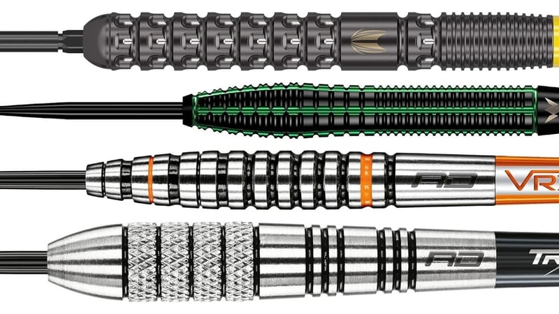 Four darts laid horizontally to compare barrel shapes: a straight barrel, a straight barrel with a rounded bull nose, a stepped tapered barrel and a classic torpedo