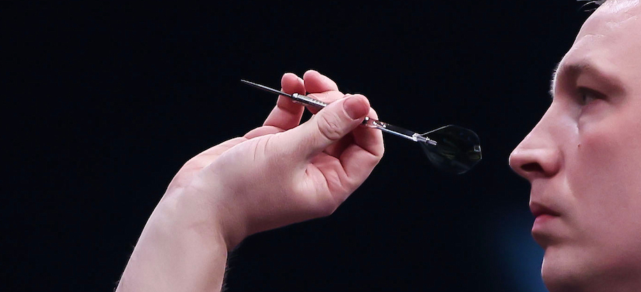 Close-up of Chris Dobey's grip on a dart, showing finger placement on the barrel