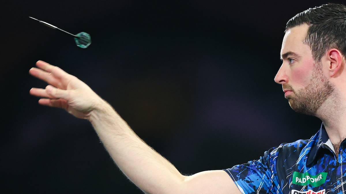 Luke Humphries demonstrating proper follow-through with his arm extended towards the target