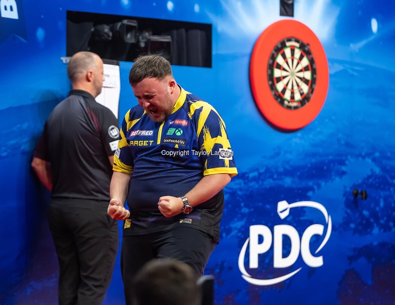 Luke Littler celebrates on stage at the Winter Gardens during the 2025 World Matchplay in Blackpool