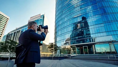 A photographer getting photos of an office building.