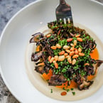 @ someone who you'd split your Roasted Mushrooms with 🍄😋 This veg-forward dish features fire-roasted hen of the woods mushroom ploom nestled on top of ultra-creamy house-made tahini, sprinkled with toasted pine nuts and topped with chives 〰️ a must-try for all mushroom lovers out there!