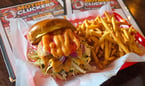 Traditional Smash Burger -&nbsp;A juicy smashed beef patty topped with melted White American cheese, crisp lettuce, fresh tomato, sliced onion, and our signature Mother Clucking Sauce on a toasted bun. Served with your choice of side. $12.95