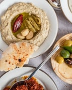 long-weekend meze box comin' in hot 😍 this kit includes four house-made dips of your choice: labneh, muhammara, tzatziki, hummus, babba ghanoush or sunflower tahini, marinated olives, and 4 za'atar pocketed pitas. pre-order yours today by tapping that link in our bio 😍