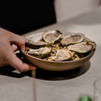 six oysters // six (6) oysters + pomegranate vinegar mignonette + horseradish + lemon