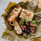 be-leaf us, you need to stop in + try our grape leaf wrapped feta ✨ features honey roasted figs, arak + basil for a perfect balance of flavours that's great for sharing 😋