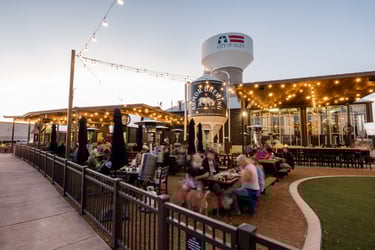 A lively outdoor bar overlooking the lawn.