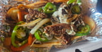 What The Cluck Philly Cheesesteak - Tender sliced ribeye steak piled high with melted cheese, sautéed mushrooms, grilled onions, bell peppers, jalapeños, and creamy mayo on a toasted roll. Served with your choice of side. $15.95