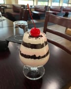 Black Forest Trifle — layers of cherry mousse, vanilla mousse, and rich brownie crumble. A classic combination reimagined.

#SweetTooth #ItalianFlavors #HomemadeGoodness #DineInStyle #TreatYourself #FoodieFavorites