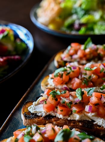 Goat cheese, fresh Roma tomato, red onion, torn basil, and EVOO on grilled ciabatta. The Bella Bruschetta is the kind of antipasti that looks simple and earns its place on the table anyway. 

📸 Bella Bruschetta 

#bellabrava #stpete #bruschetta #antipasti #italianfood