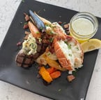 Surf & turf perfection 🍽️ | Indulge in our 6oz lobster tail paired with a 5oz prime-grade top sirloin, pancetta, garlic whipped potatoes, roasted rainbow carrots, balsamic tomatoes, and a touch of lemon. Finished with herby compound butter & melted butter for the ultimate flavor experience. #PrimeCutsSteakhouse #SurfAndTurf #SteakLovers #ItalianSteakhouse #FoodieFavorites