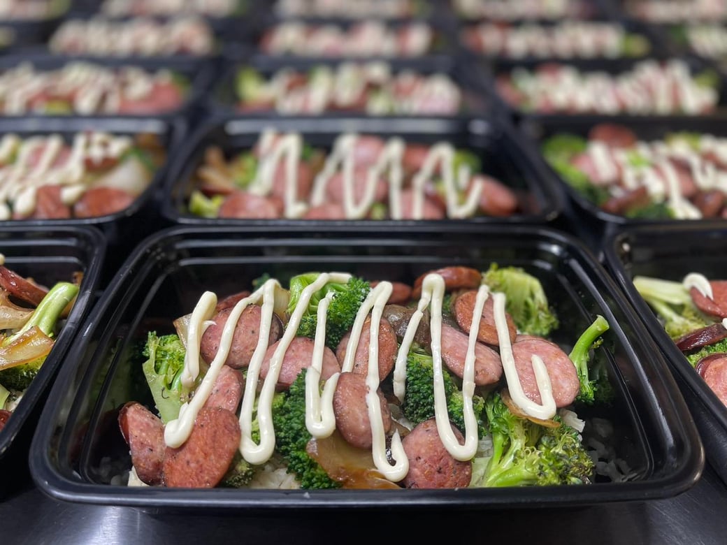 Seared kielbasa over brown rice w/ broccoli, onions, and garlic white wine sauce