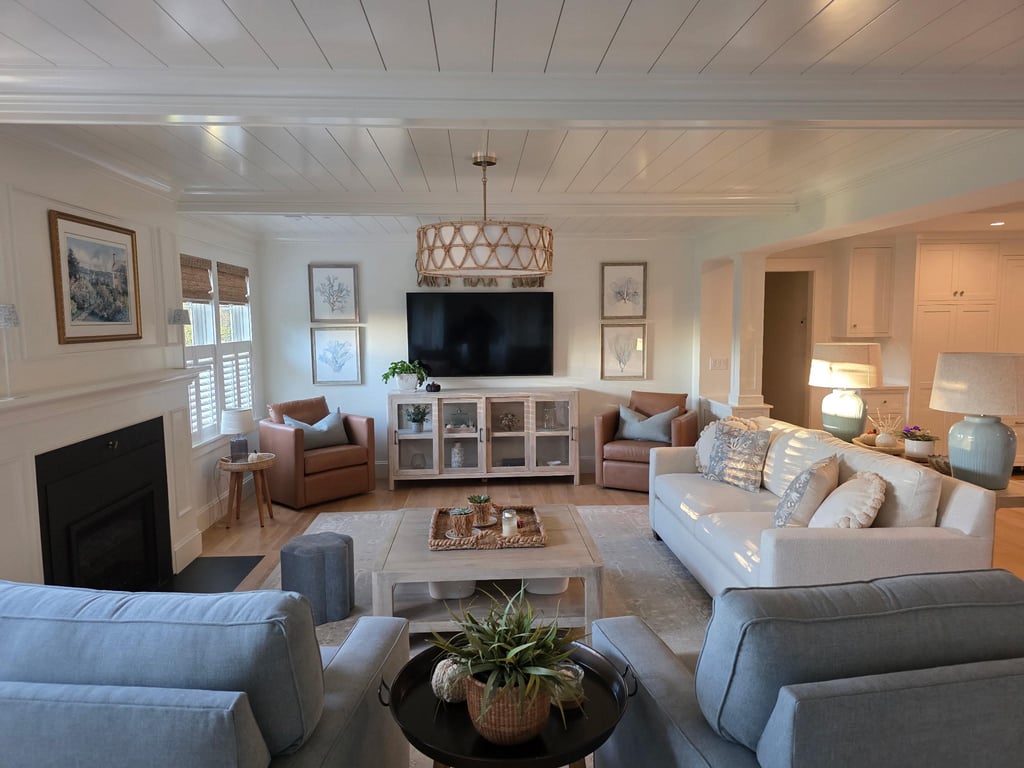Finished living room in Marion with white shiplap ceiling, fireplace, entertainment center, multiple seating areas, and pendant lighting.