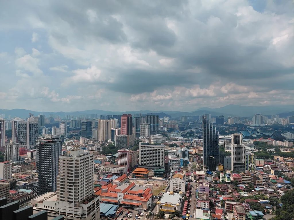 The Kuala Lumpur skyline stretching to the hills in daylight