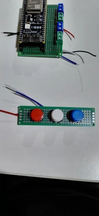 ESP32-S3 main perfboard and separate red, white and blue button perfboard during assembly