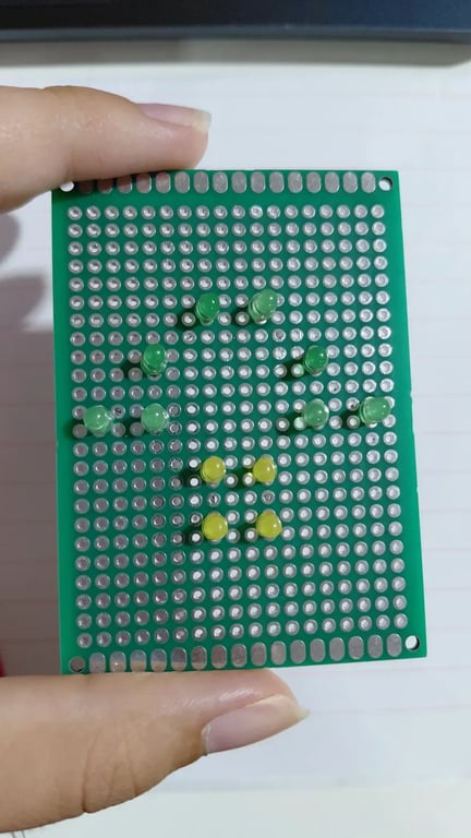 Green and yellow LEDs installed in a mushroom pattern before the circuit was completed