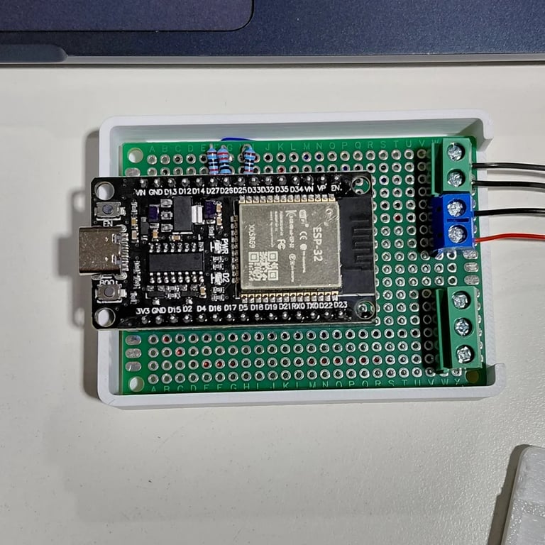Open controller enclosure showing the soldered perfboard, ESP32, terminal blocks and removable carrier