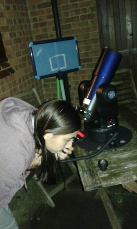 Looking through a telescope at night