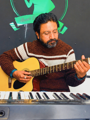 Rahul, founder of The Music Room, playing guitar