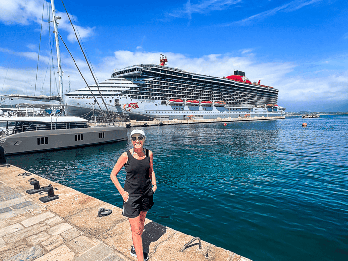 Jenny Lynn Anderson standing in front of a cruise ship.