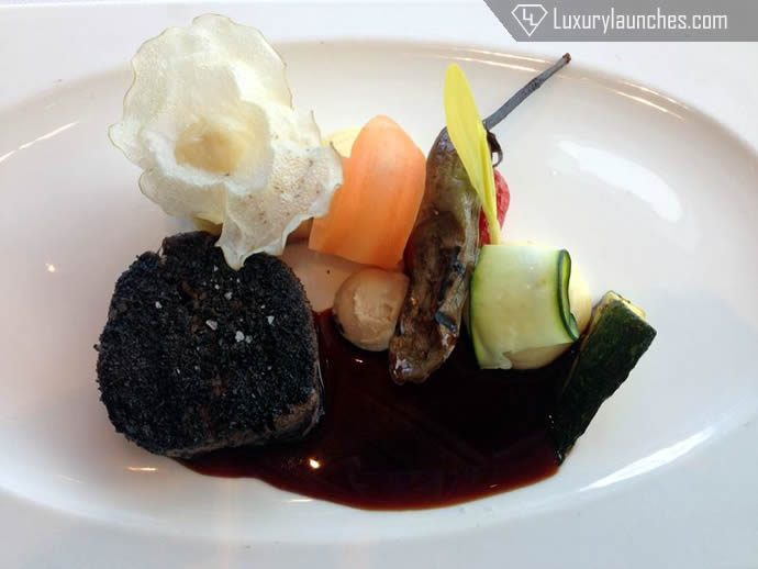Charcoal glazed aged beef tenderloin foie gras, baked potato cake, crispy roots and grilled vegetables